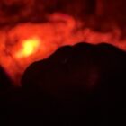 Flame at the end of the road - blurry and black and red.