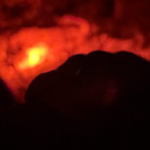 Flame at the end of the road - blurry and black and red.