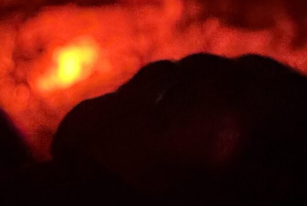 Flame at the end of the road - blurry and black and red.